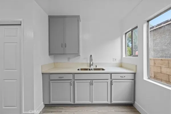a kitchen with stainless steel appliances granite countertop a sink and cabinets with wooden floor