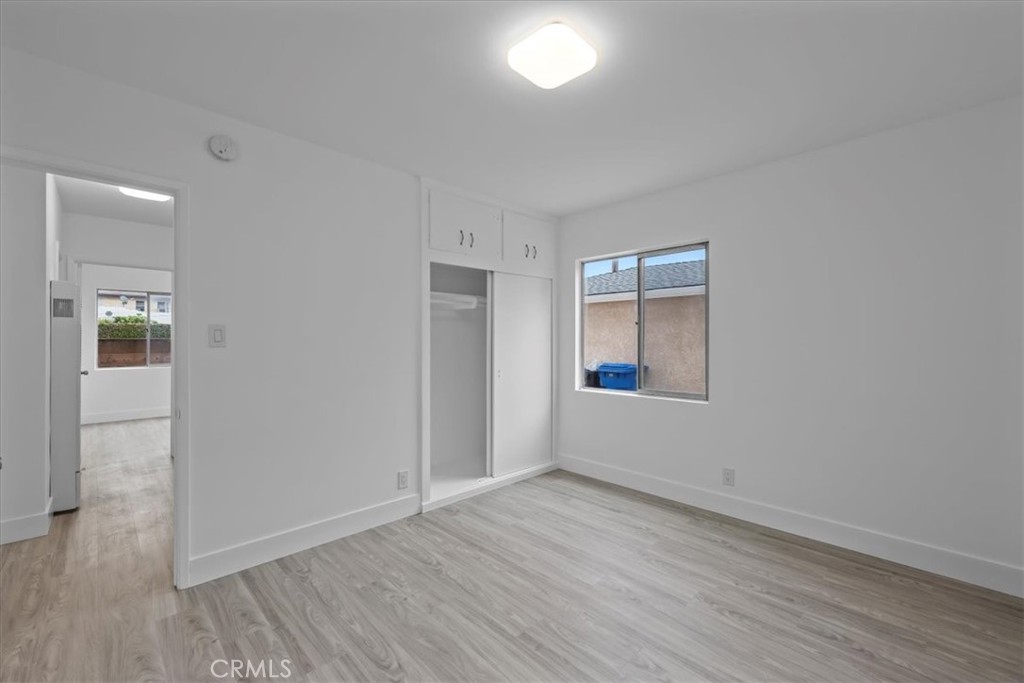 853 West 23rd Street, Unit 2 San Pedro, CA 90731 - Photo 15 of 19 an empty room with wooden floor and windows