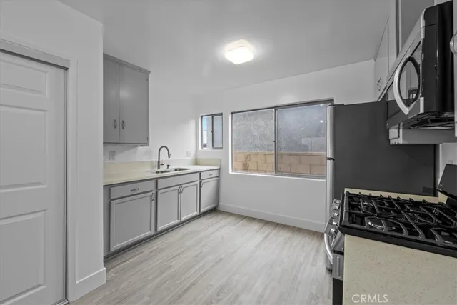 a kitchen with a sink stove and cabinets