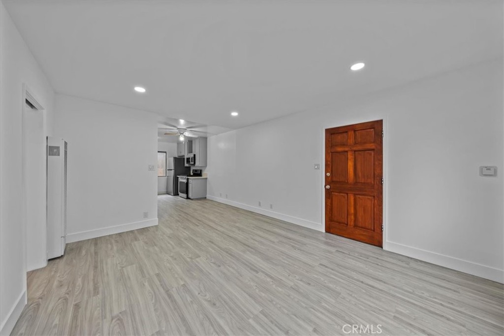 853 West 23rd Street, Unit 2 San Pedro, CA 90731 - Photo 7 of 19 a view of empty room with wooden floor and window