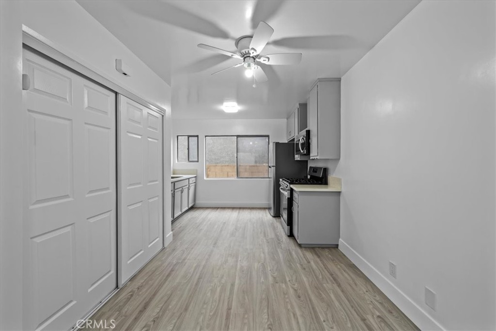 853 West 23rd Street, Unit 2 San Pedro, CA 90731 - Photo 8 of 19 a view of a kitchen with a sink and dishwasher a refrigerator with wooden floor