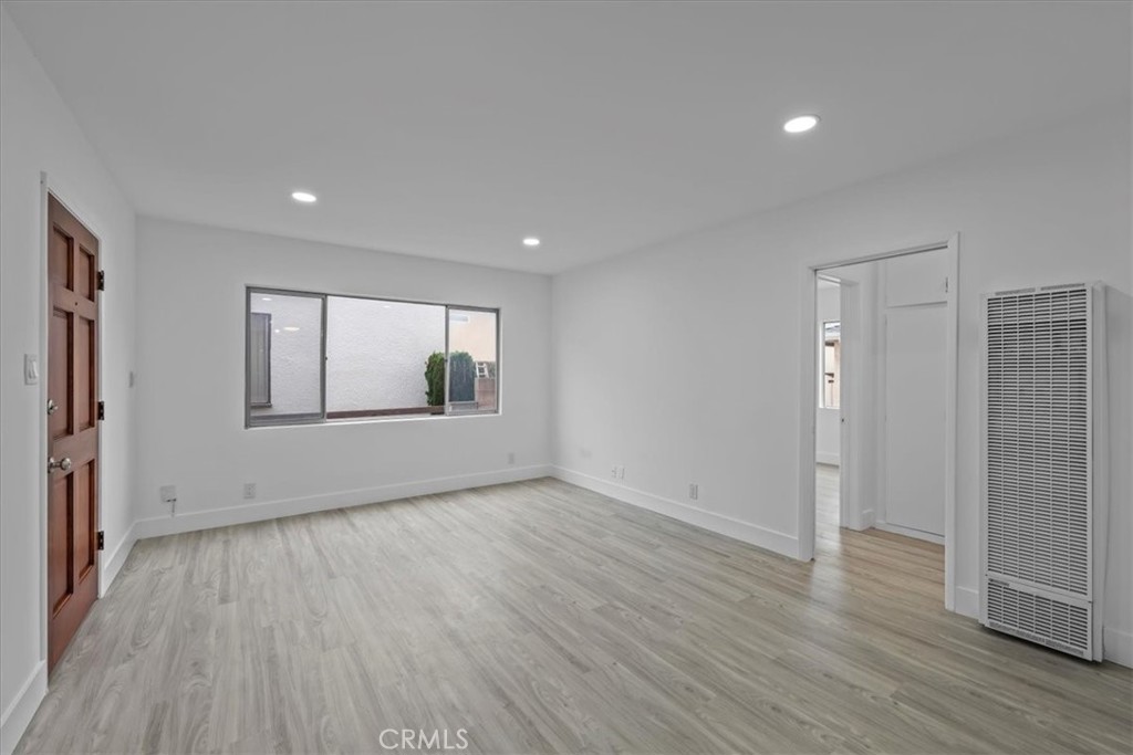 853 West 23rd Street, Unit 2 San Pedro, CA 90731 - Photo 9 of 19 a view of empty room with wooden floor and fan