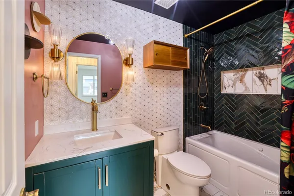 a bathroom with a sink a toilet and mirror
