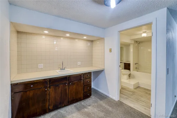 a bathroom with a sink a mirror and a shower