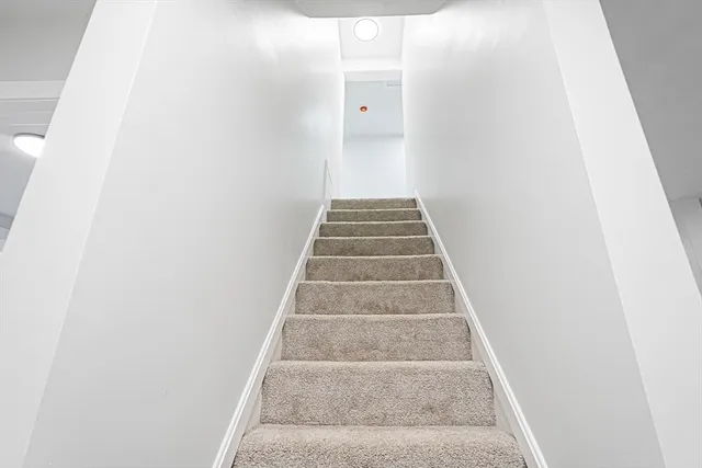 a view of staircase with white walls