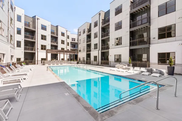 a view of building with swimming pool and outdoor seating