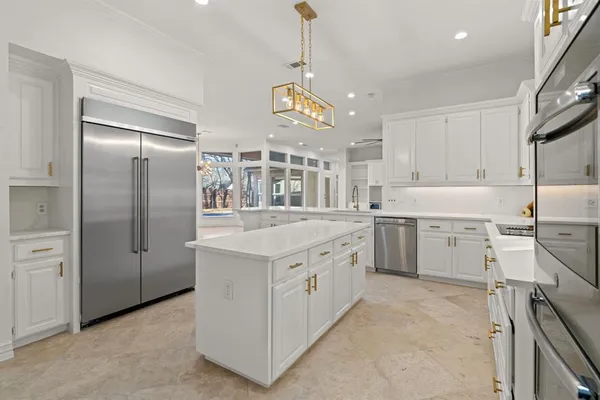 a kitchen with a sink appliances and cabinets
