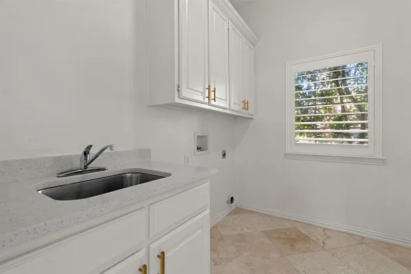 a kitchen with a sink and cabinets