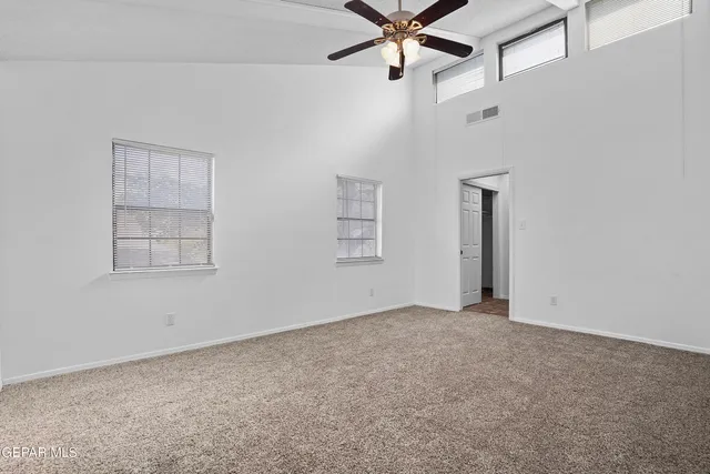 an empty room with a empty space and a ceiling fan