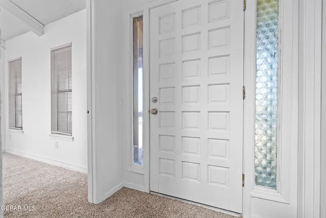 a view of an empty room with a fireplace and a large window