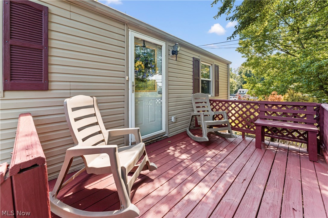 7000 Navarre Road Southwest Massillon, OH 44646 - Photo 5 of 22 The property features an exterior deck with a wooden railing and latticework
