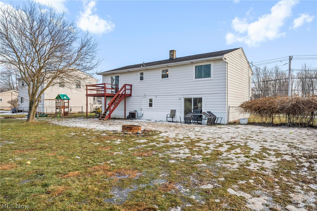1088 Novak Road Grafton, OH 44044 - Photo 28 of 33 Rear view of house with a patio, a wooden deck, a chimney, and an outdoor fire pit