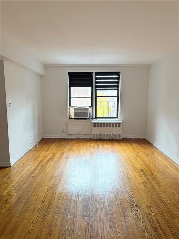 9511 Shore Road, Unit 617 Brooklyn, NY 11209 - Photo 4 of 14 an empty room with a window and wooden floor