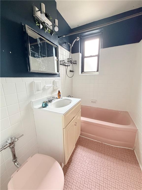 9511 Shore Road, Unit 617 Brooklyn, NY 11209 - Photo 9 of 14 a bathroom with a sink a toilet and bathtub