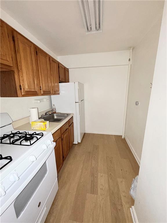 9511 Shore Road, Unit 617 Brooklyn, NY 11209 - Photo 10 of 14 a kitchen with a stove a sink and a refrigerator