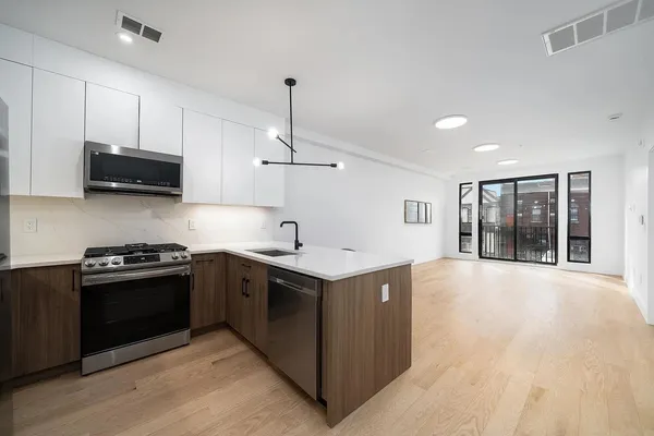 a kitchen with stainless steel appliances granite countertop a stove and a sink