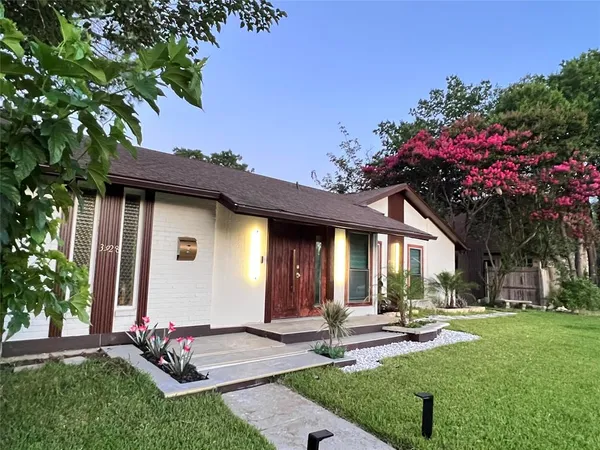 a front view of a house with garden