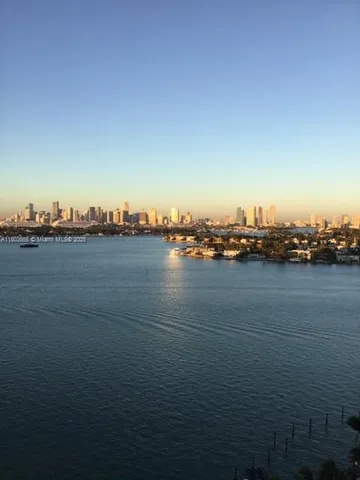 a kitchen with stainless steel appliances a stove a refrigerator a sink and white cabinets next to a window