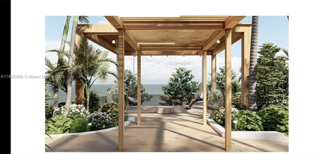 a view of a dining room with furniture large windows and a chandelier