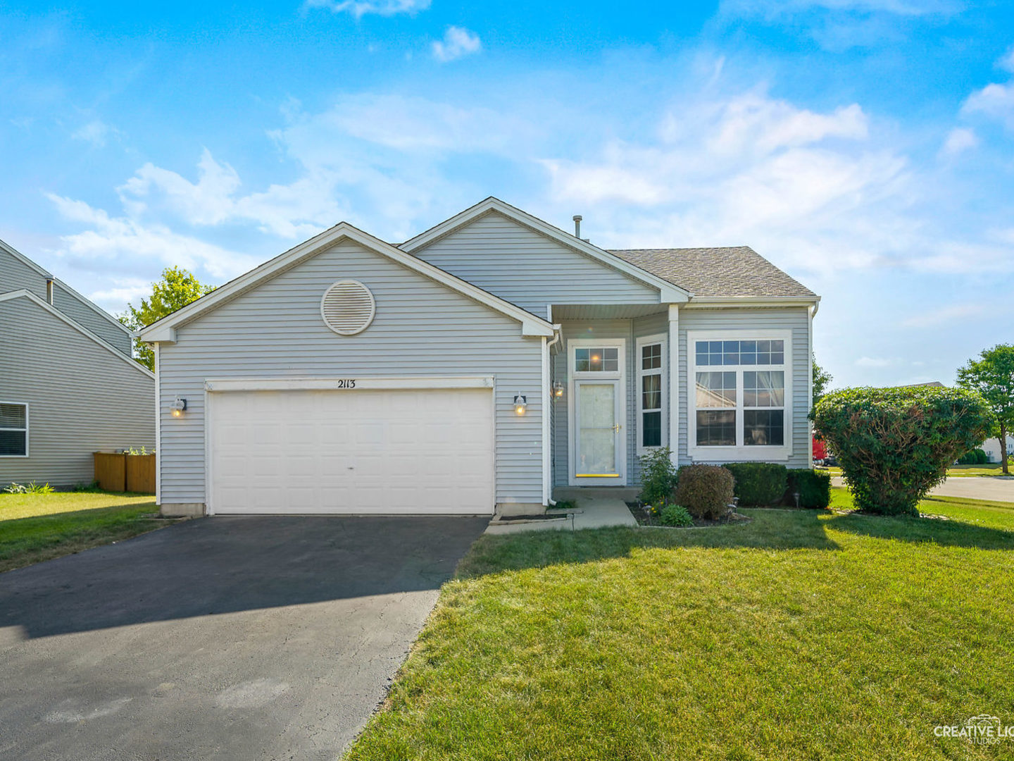 2113 Beldon Court Plainfield, IL 60586 - Photo 23 of 25 a front view of a house with a yard and garage