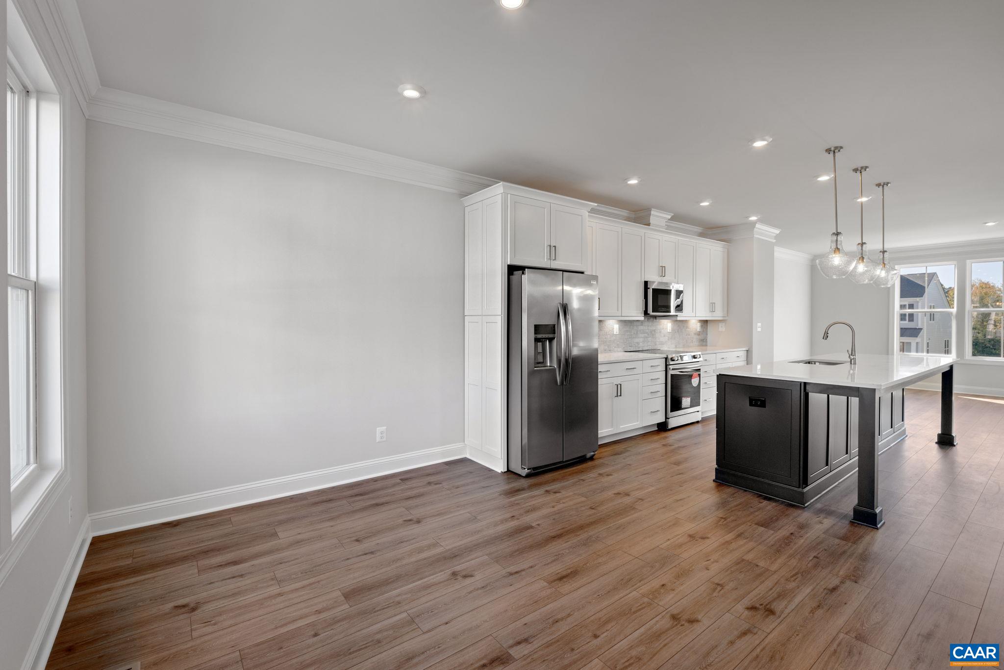7 Ryan Way Charlottesville, VA 22911 - Photo 13 of 36 a kitchen with stainless steel appliances kitchen island wooden floors and white cabinets