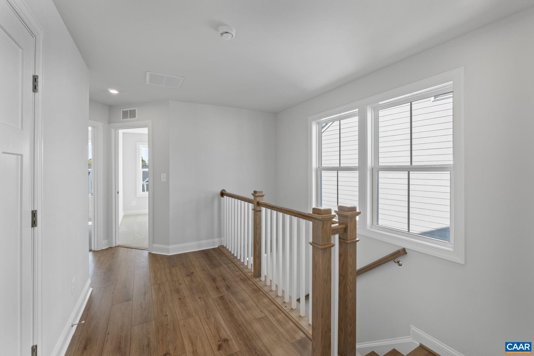 7 Ryan Way Charlottesville, VA 22911 - Photo 26 of 36 a view of a hallway with wooden floor and staircase