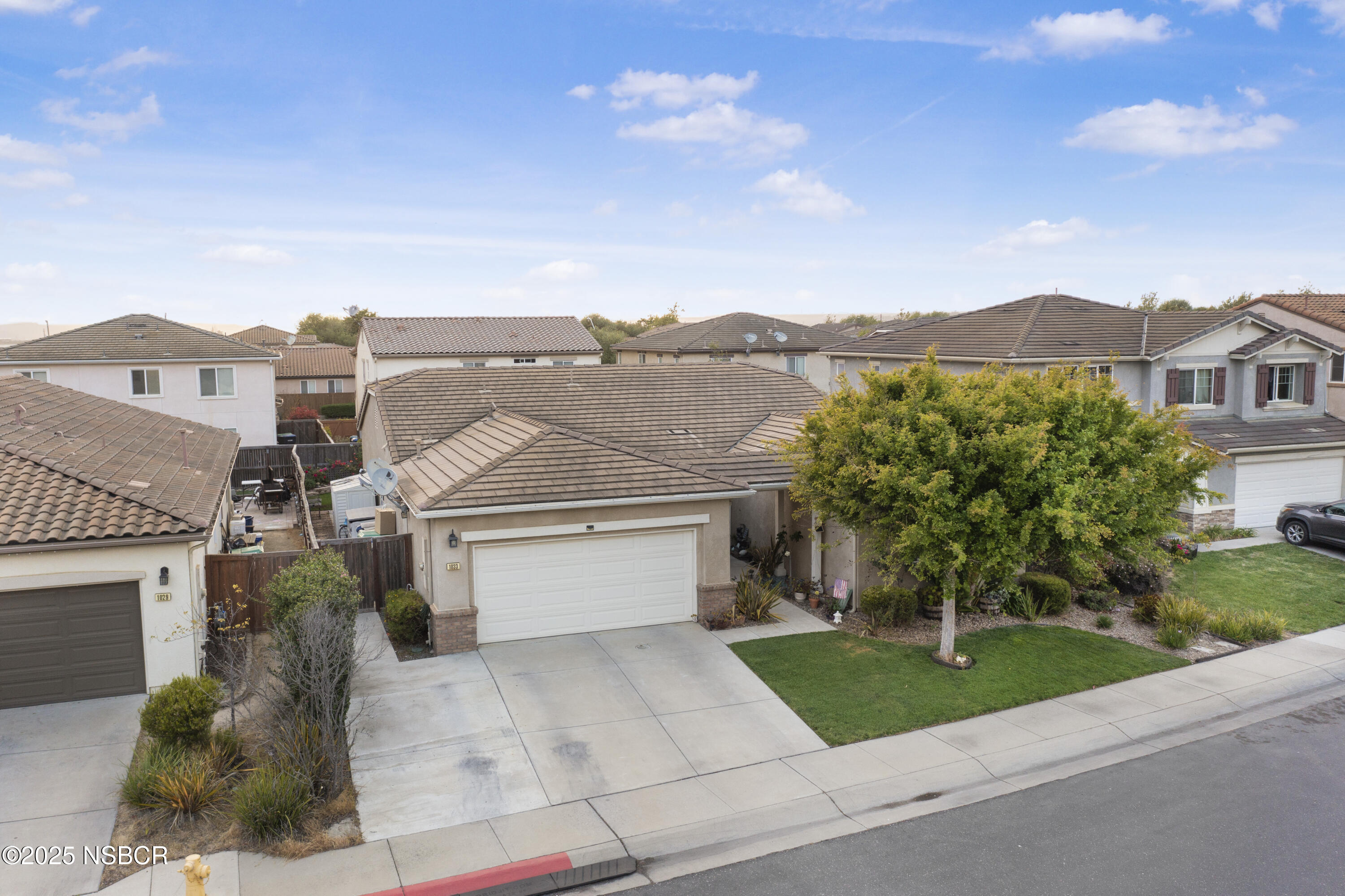 1033 Conception Drive Lompoc, CA 93436 - Photo 3 of 18 a front view of a house with a yard and garage