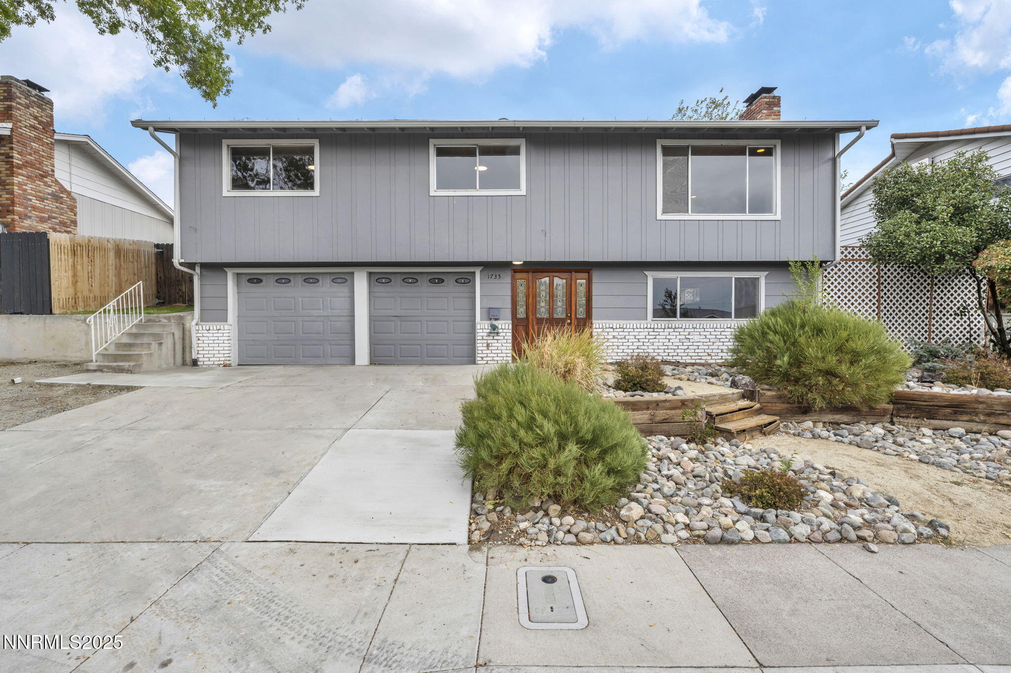 1735 Carlin Street Reno, NV 89503 - Photo 15 of 73 a front view of a house with a yard and potted plants
