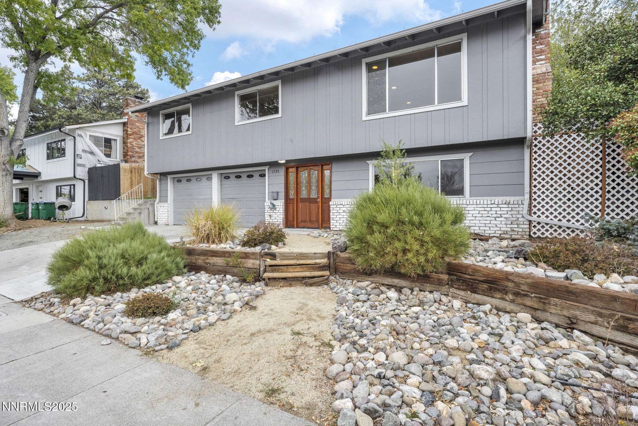 1735 Carlin Street Reno, NV 89503 - Photo 26 of 73 a front view of a house with a yard and a garage