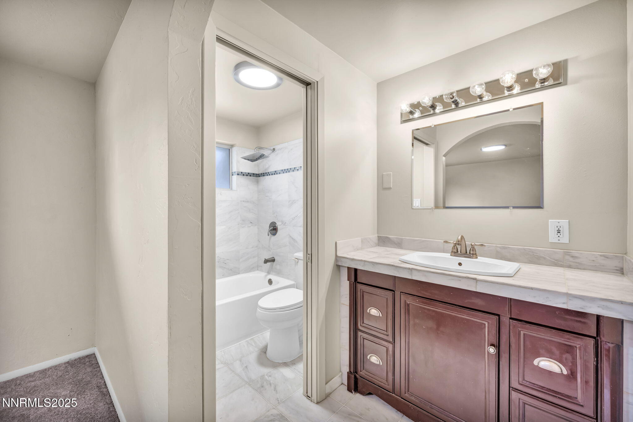1735 Carlin Street Reno, NV 89503 - Photo 35 of 73 a bathroom with a toilet a sink and mirror