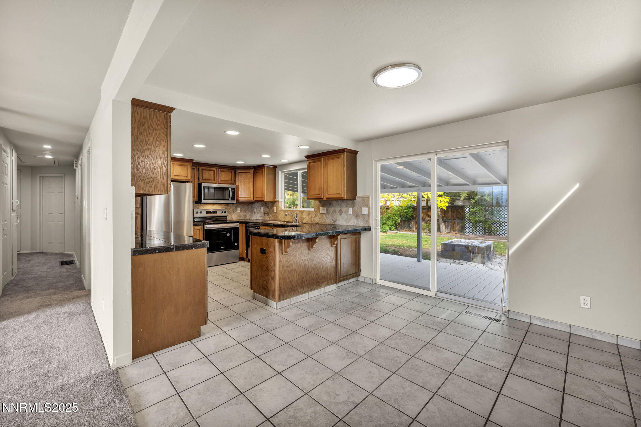 1735 Carlin Street Reno, NV 89503 - Photo 58 of 73 a kitchen with stainless steel appliances granite countertop a refrigerator and a stove