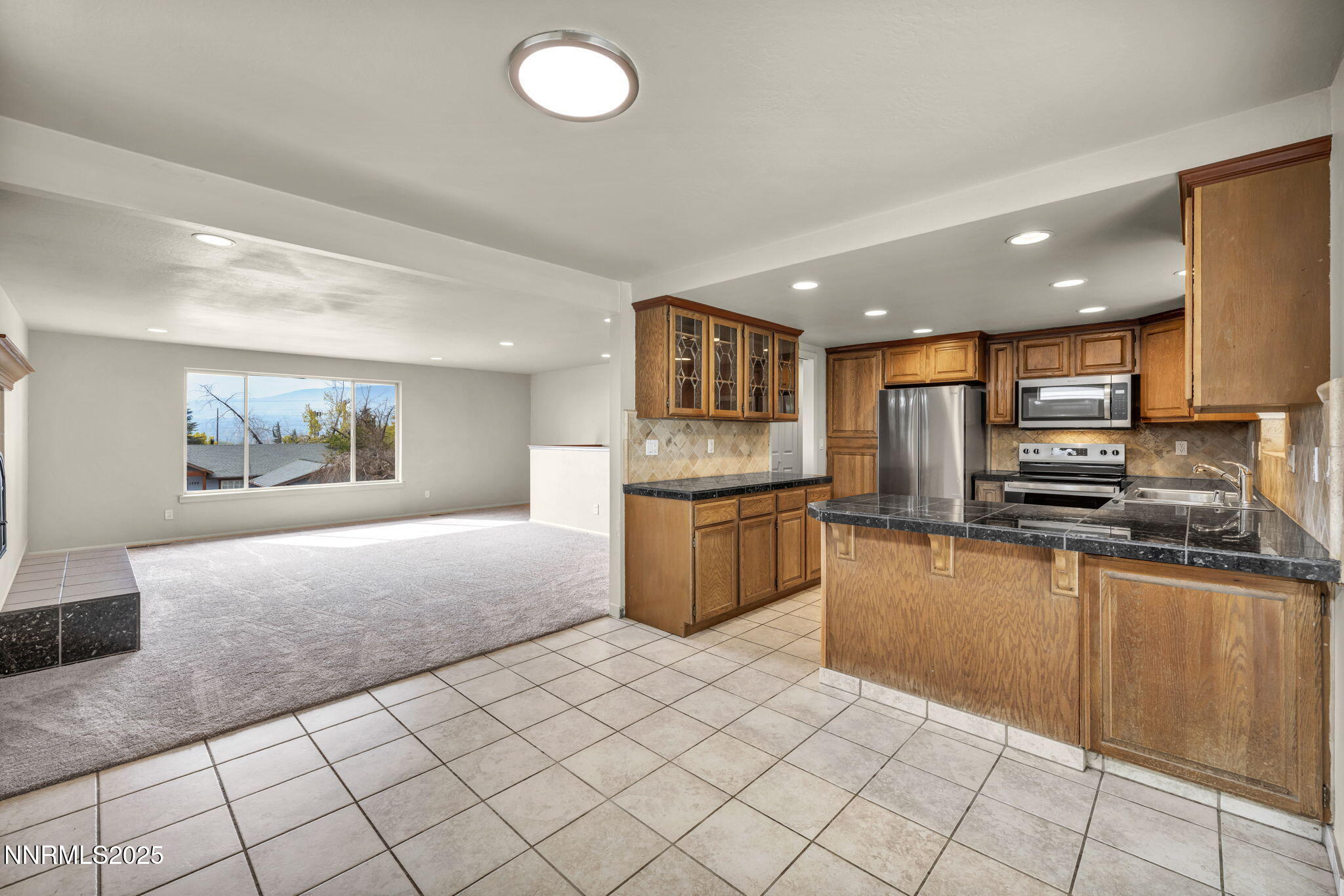1735 Carlin Street Reno, NV 89503 - Photo 59 of 73 a large kitchen with stainless steel appliances kitchen island granite countertop a sink and cabinets