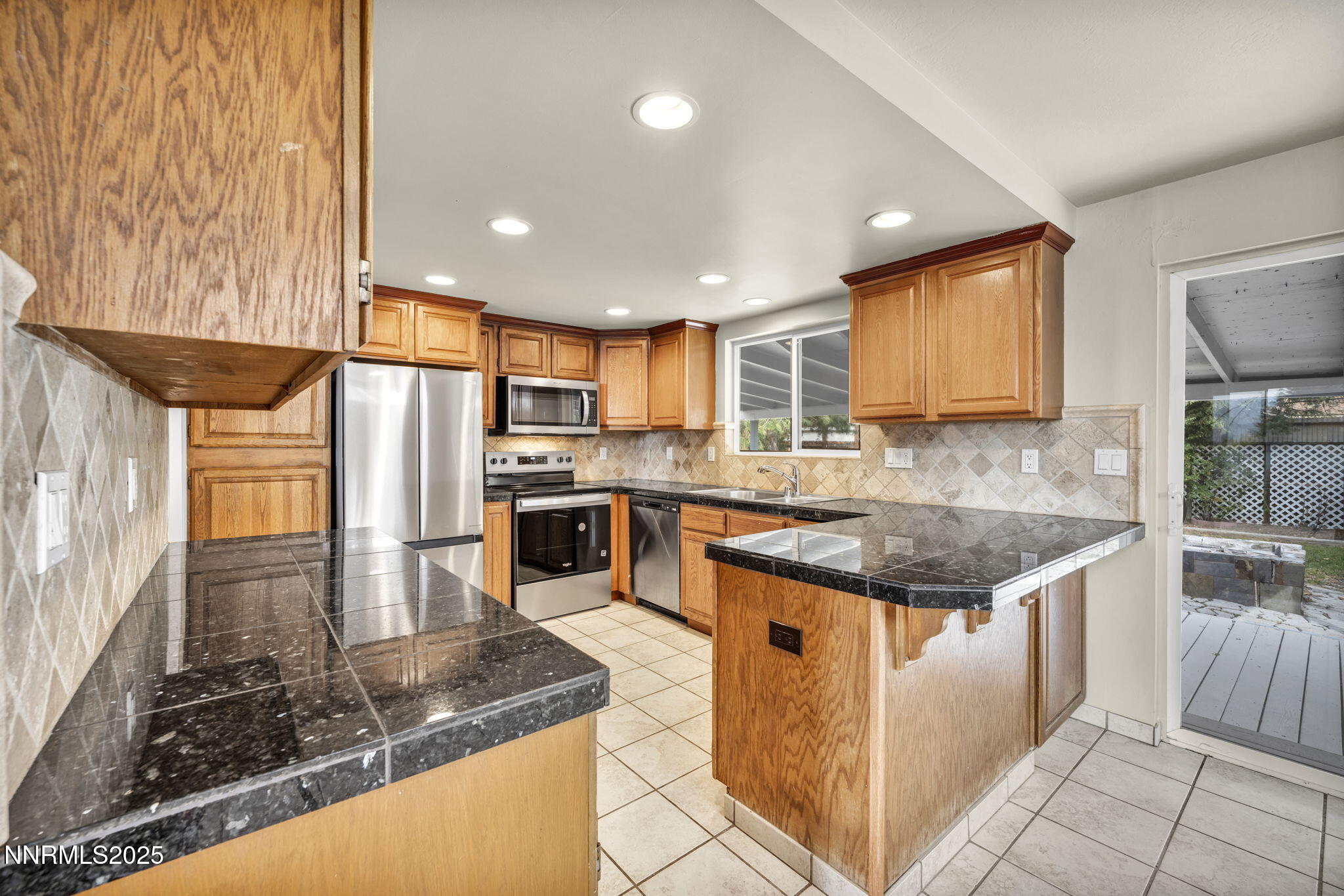 1735 Carlin Street Reno, NV 89503 - Photo 60 of 73 a kitchen with stainless steel appliances granite countertop a sink stove and refrigerator