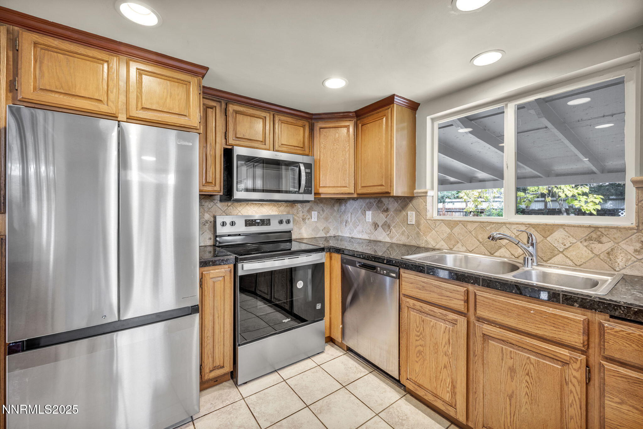 1735 Carlin Street Reno, NV 89503 - Photo 62 of 73 a kitchen with stainless steel appliances granite countertop a refrigerator a sink a stove and cabinets