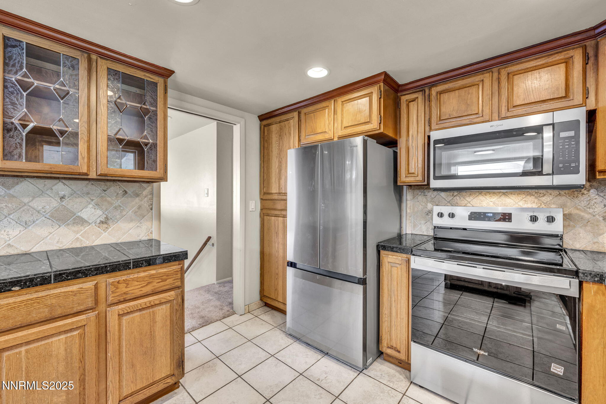 1735 Carlin Street Reno, NV 89503 - Photo 63 of 73 a kitchen with stainless steel appliances granite countertop a refrigerator and a stove top oven