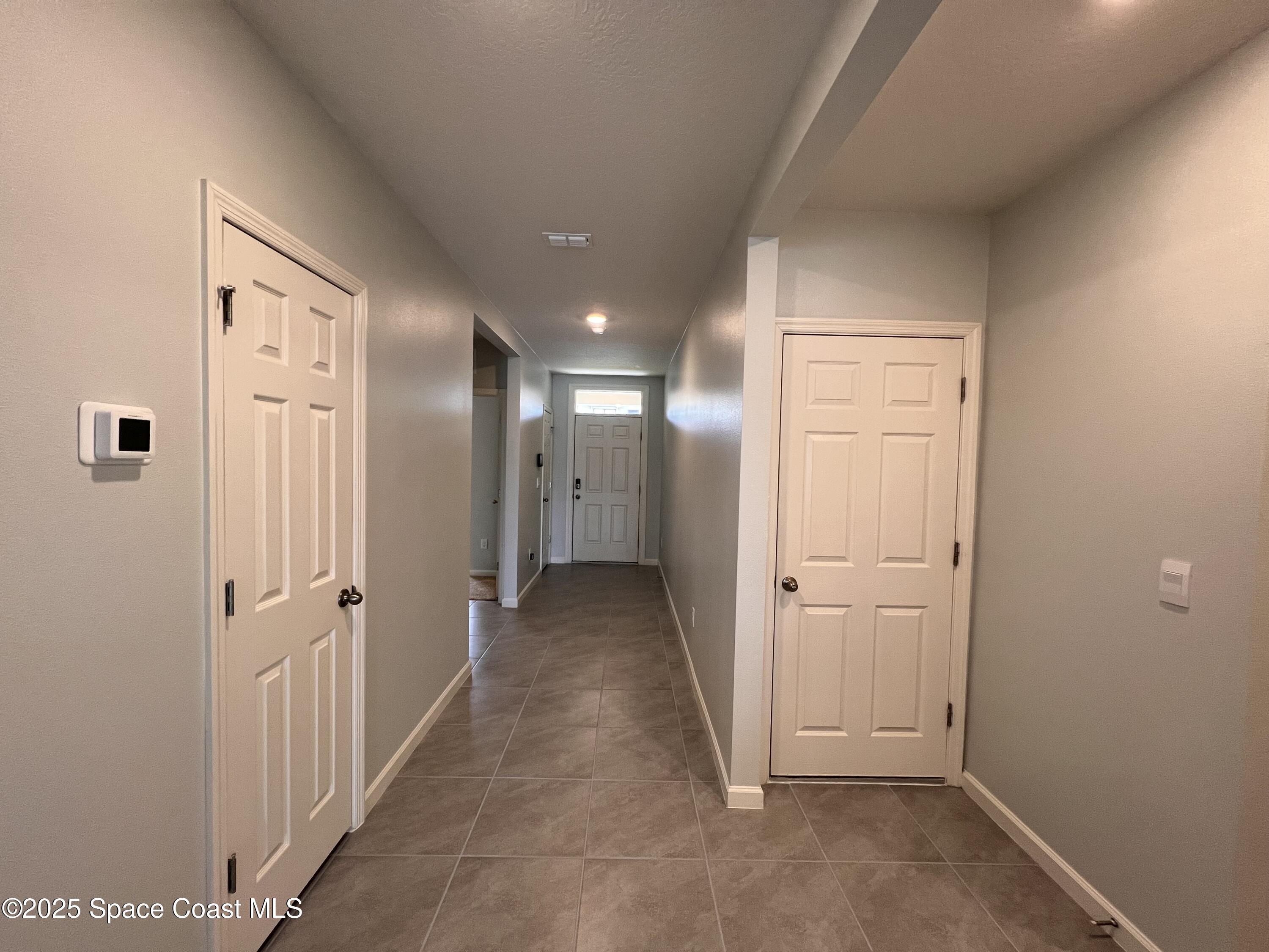 4871 Talbot Boulevard Cocoa, FL 32926 - Photo 13 of 25 wooden floor in a hall with an entryway