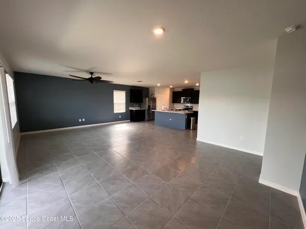 a view of a kitchen with a sink and a refrigerator