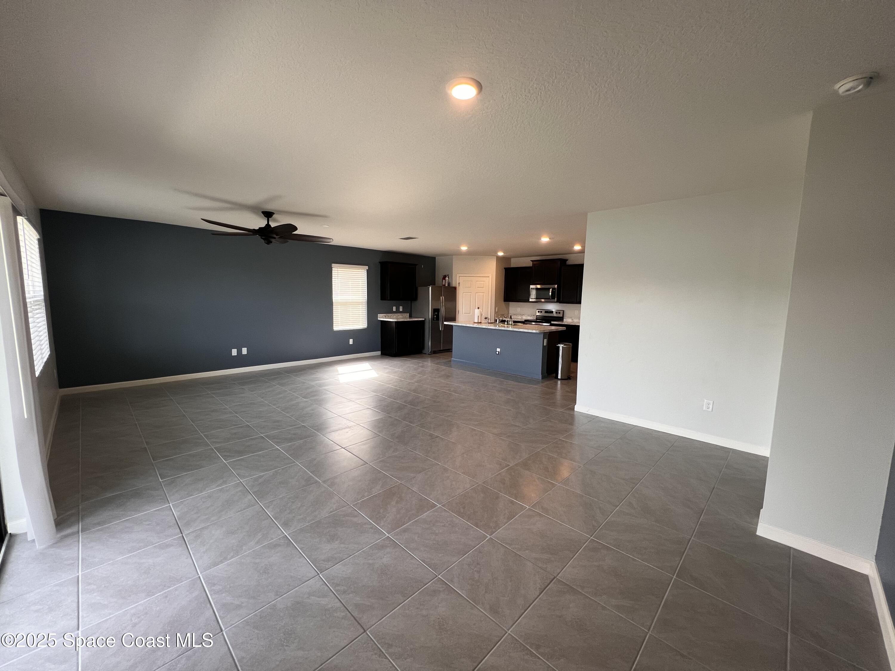 4871 Talbot Boulevard Cocoa, FL 32926 - Photo 17 of 25 a view of a kitchen with a sink and a refrigerator