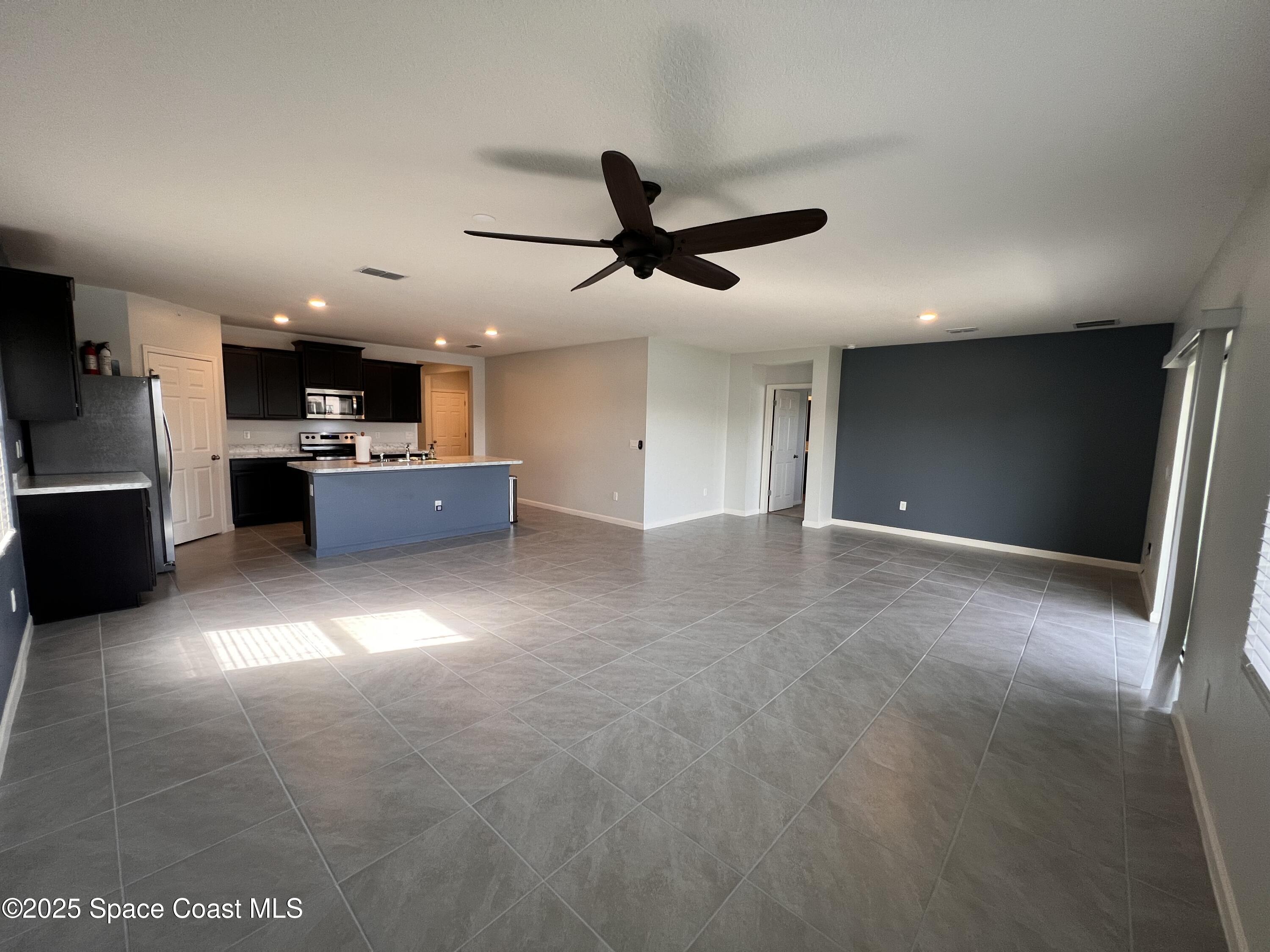 4871 Talbot Boulevard Cocoa, FL 32926 - Photo 18 of 25 a view of a kitchen with a sink and a refrigerator