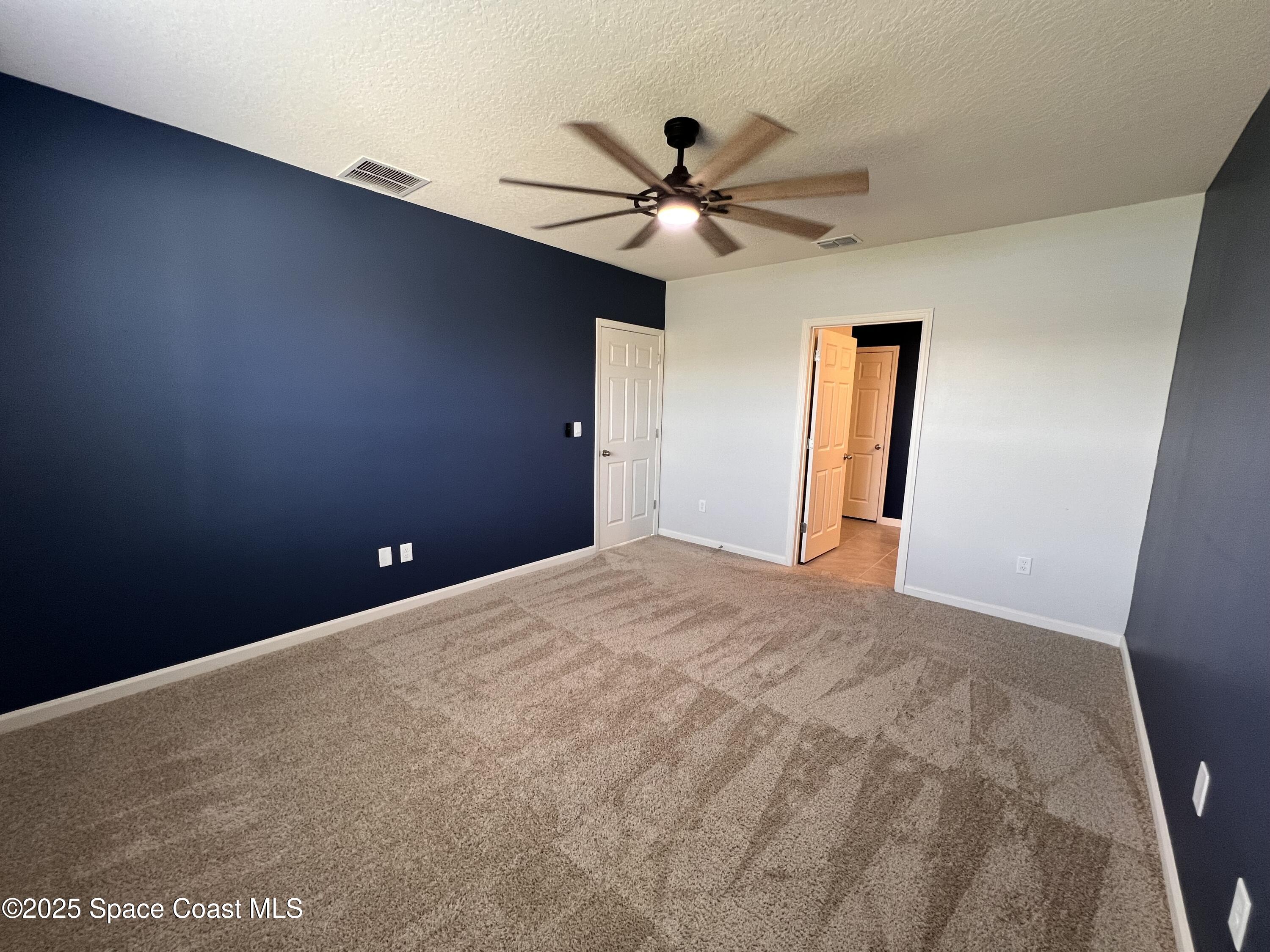 4871 Talbot Boulevard Cocoa, FL 32926 - Photo 21 of 25 a view of a room with a ceiling fan