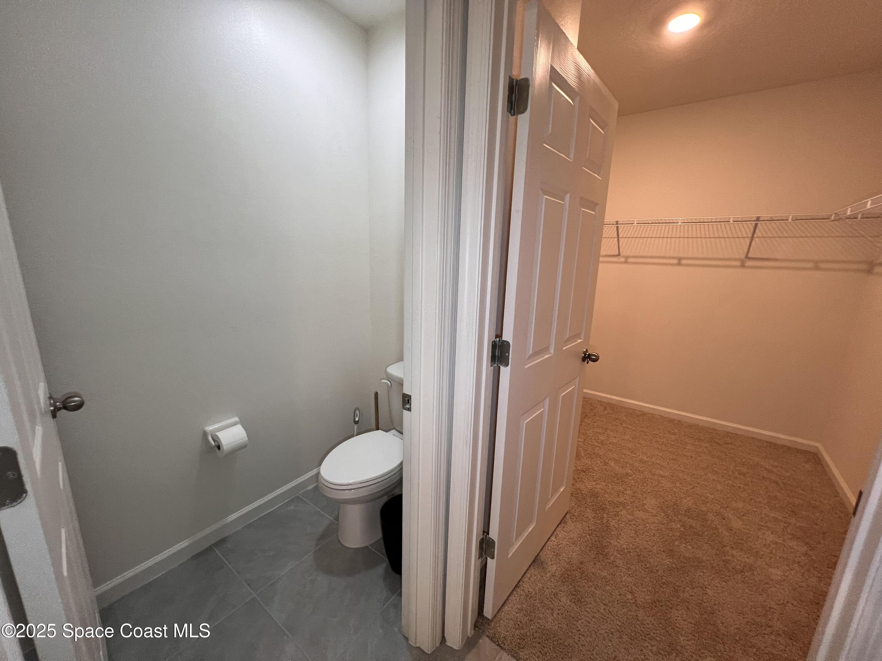 4871 Talbot Boulevard Cocoa, FL 32926 - Photo 23 of 25 a bathroom with a toilet and a shower