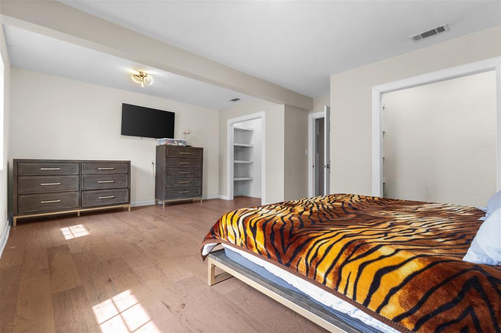 145 Lawson Road Mesquite, TX 75181 - Photo 12 of 31 a bedroom with a bed and a television