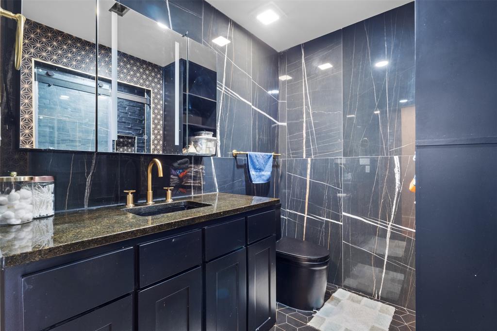 145 Lawson Road Mesquite, TX 75181 - Photo 14 of 31 a bathroom with a sink a toilet and shower