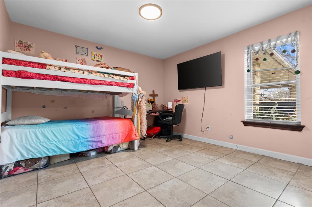 145 Lawson Road Mesquite, TX 75181 - Photo 15 of 31 a bedroom with a bed and a flat screen tv