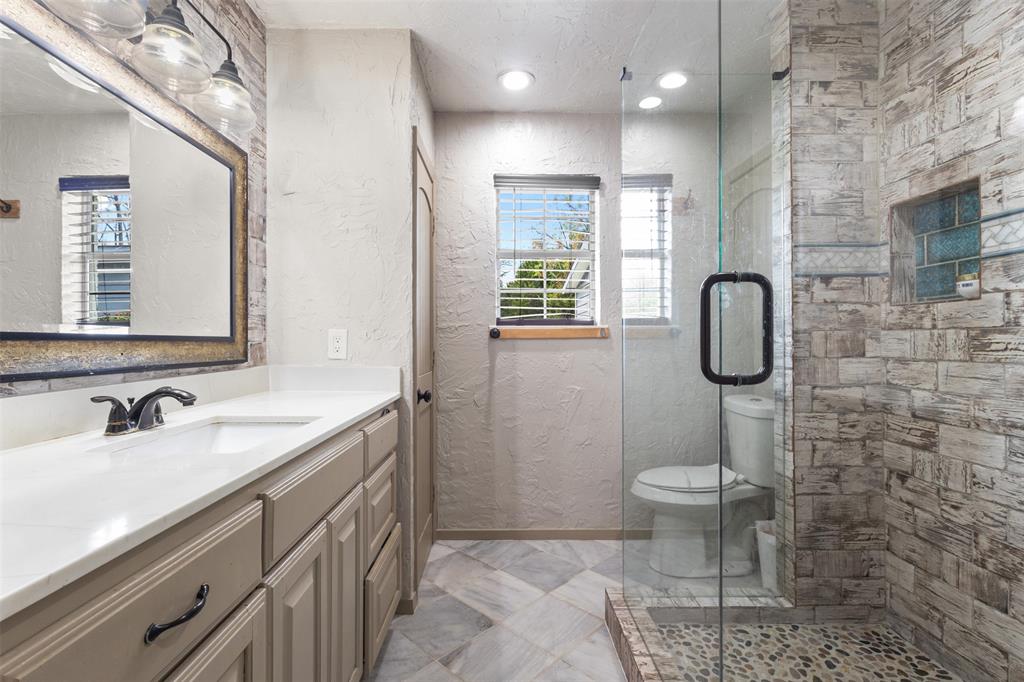 145 Lawson Road Mesquite, TX 75181 - Photo 16 of 31 a bathroom with a sink a toilet and shower