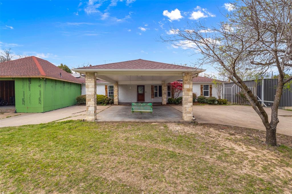 145 Lawson Road Mesquite, TX 75181 - Photo 2 of 31 a view of a white house with a big yard and large trees