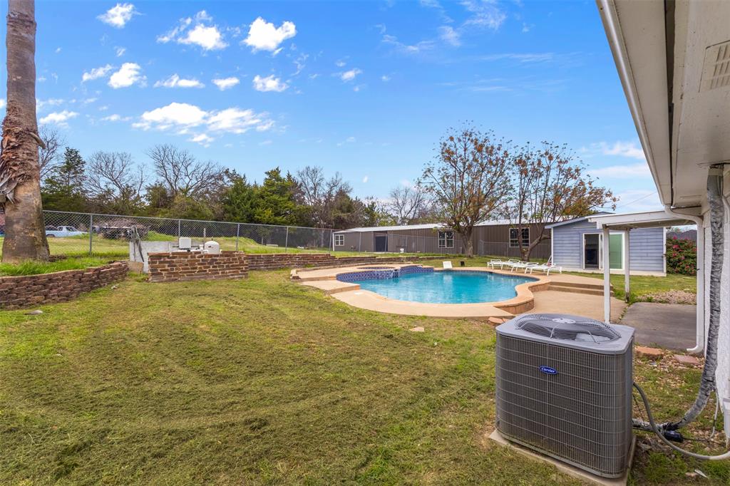 145 Lawson Road Mesquite, TX 75181 - Photo 21 of 31 a view of a swimming pool with a patio and a yard