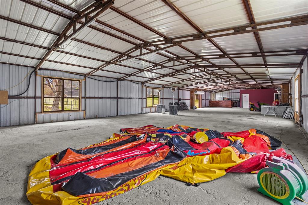 145 Lawson Road Mesquite, TX 75181 - Photo 28 of 31 a bedroom with a bed and a chandelier