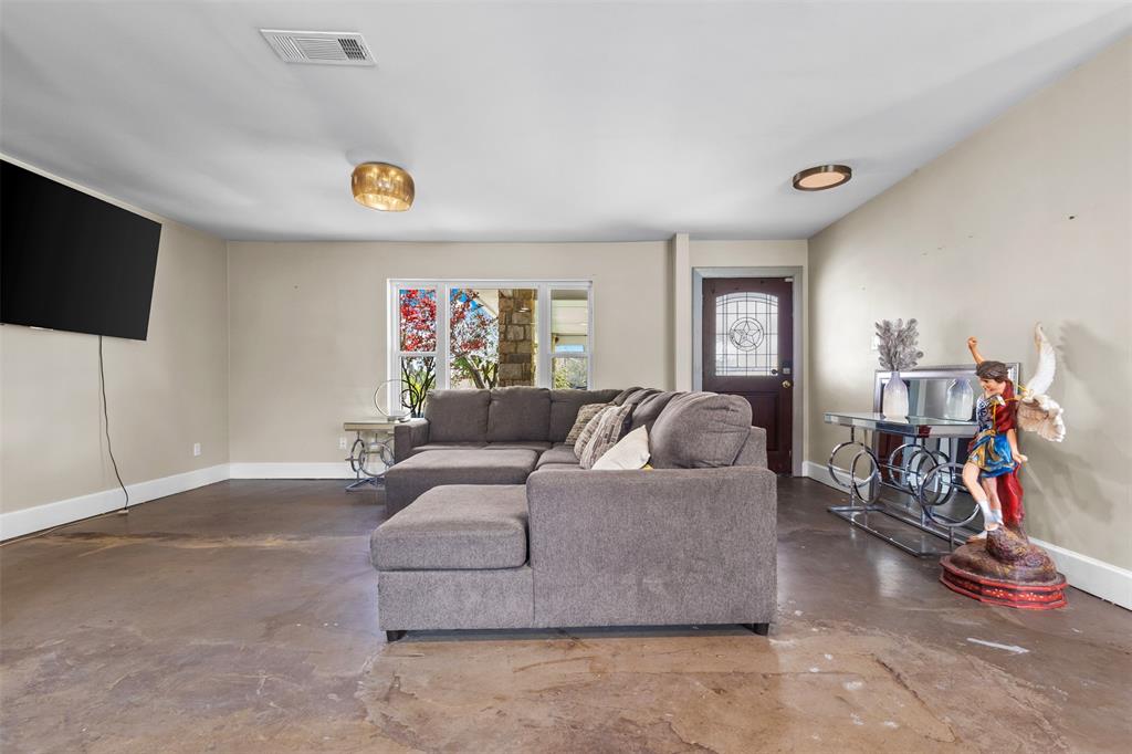 145 Lawson Road Mesquite, TX 75181 - Photo 4 of 31 a living room with furniture and a flat screen tv