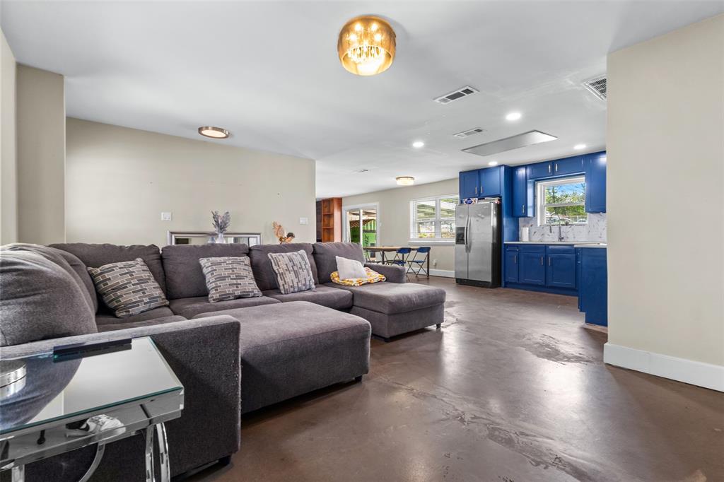 145 Lawson Road Mesquite, TX 75181 - Photo 5 of 31 a living room with furniture and a chandelier